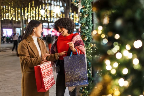 Diverse women friends enjoying christmas holiday shopping