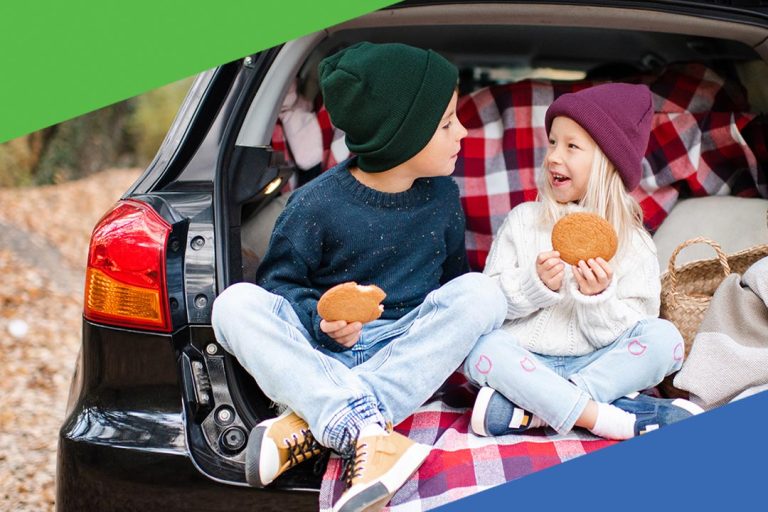 Two young children sitting in the back of a car during a family outing, highlighting Peake Credit Union’s affordable auto loan options.