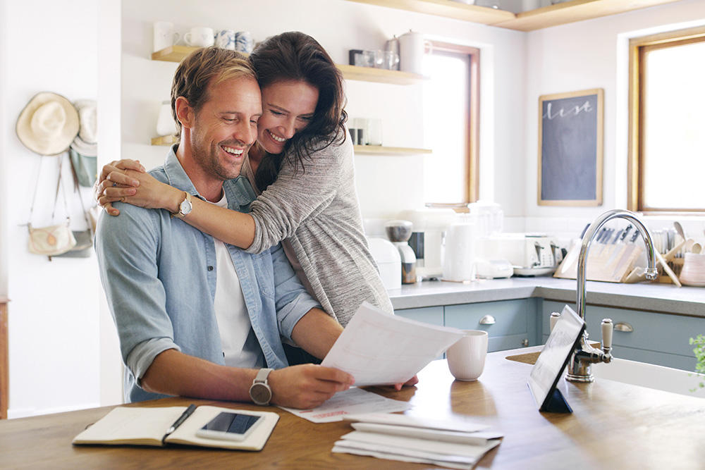 Couple reviewing household finances together, illustrating small financial habits that build momentum over time