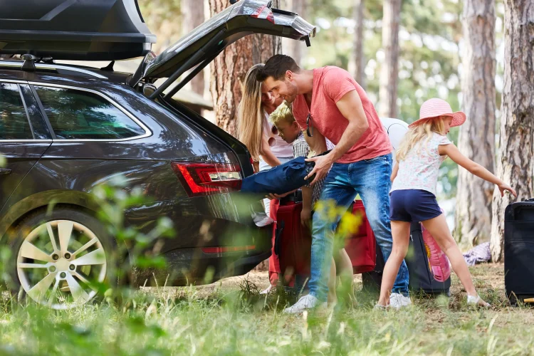 Family at the car loading with luggage