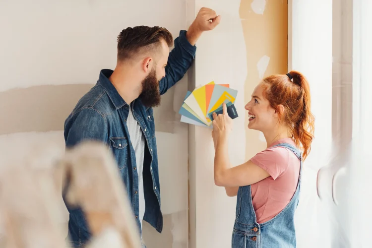 Young woman showing her choice of paint swatches