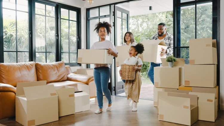 Happy african american family new-house smiling cardboard boxes