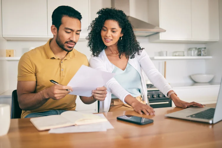 Couple paperwork and budget planning with laptop bills