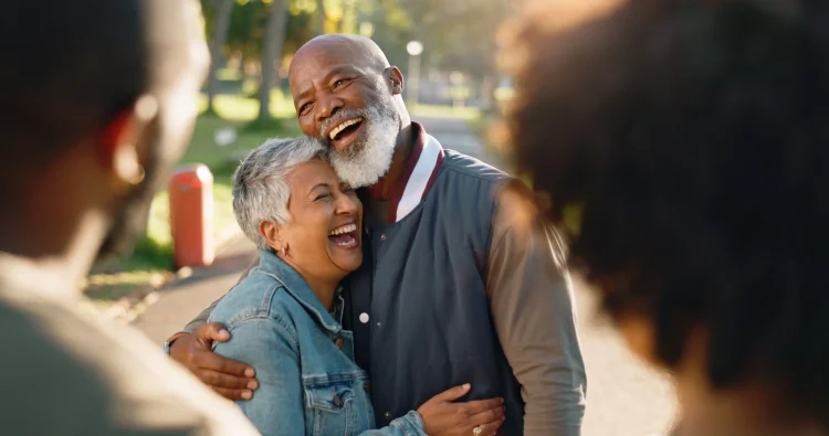 Hug, love, and senior couple in park bonding together