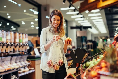 Woman shops for produce in supermarket