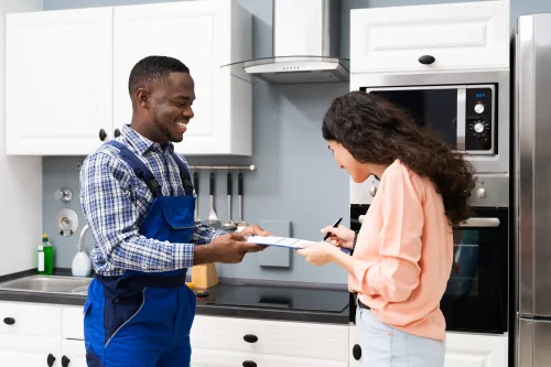 Technician Assisting Woman In Signing Invoice
